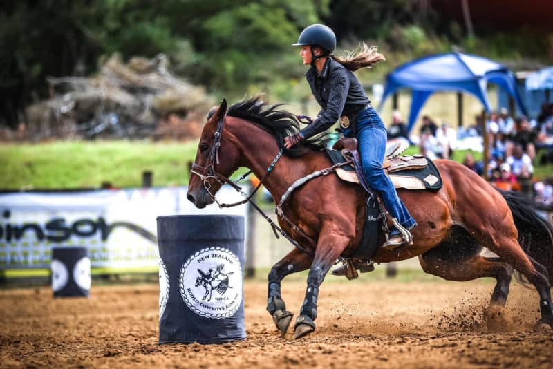 Lylah Wood, a barrel race competitor often competes in Ariat boots, Kimes Ranch jeans and a button up shirt.