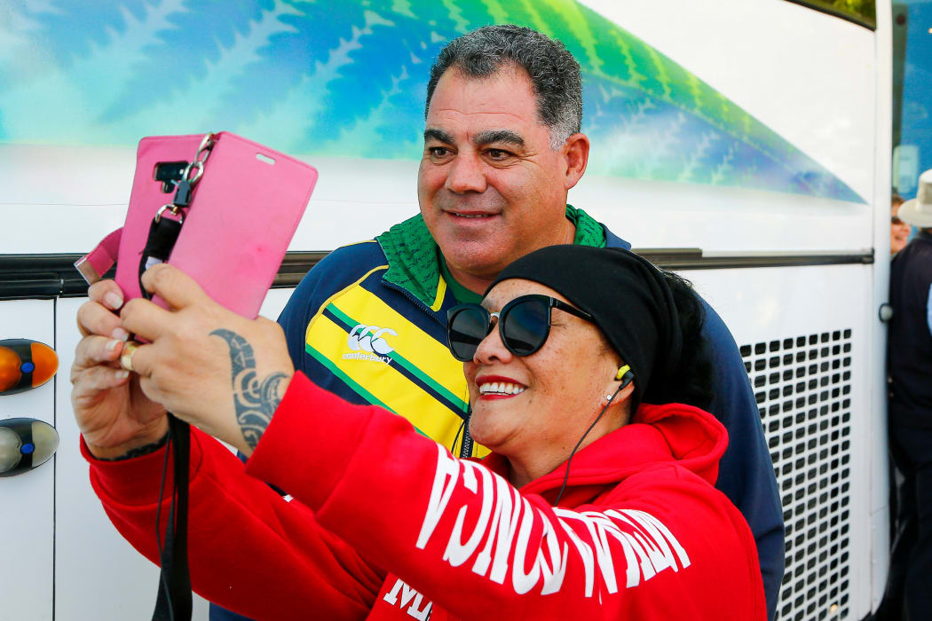 Australian coach Mal Meninga poses with a Tongan fan