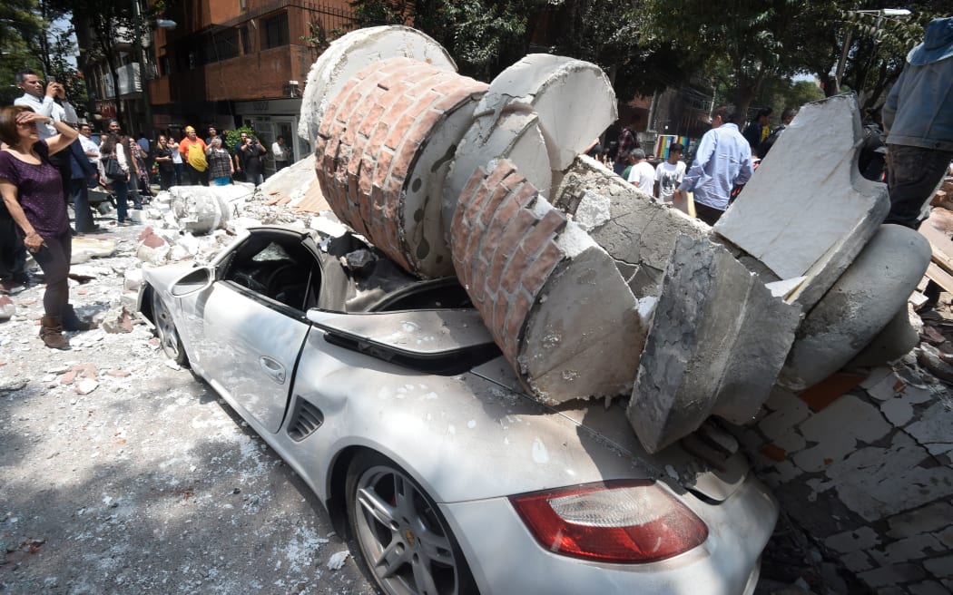 Rubble from a quake-hit building crushed a car in Mexico City.