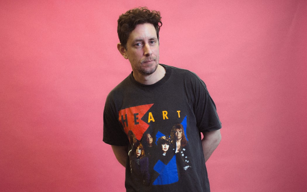 Host of RNZ's The Panel, Wallace Chapman in his Heart t-shirt