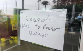 Signs in front of a laundromat, the Kerikeri Library and Unichem Pharmacy to say they are closed as there is no power on 20 June 2024 in Kerikeri, Northland.
