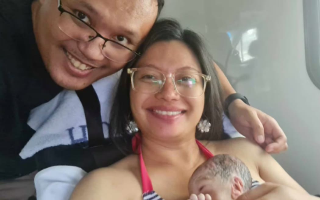 New parents Keith and Gill Bay pictured with their son Nathanael in an ambulance on the way to Waitākere Hospital after the premature baby boy was unexpectedly born in a Costco Westgate disabled toilet yesterday.

Photos supplied by NZH