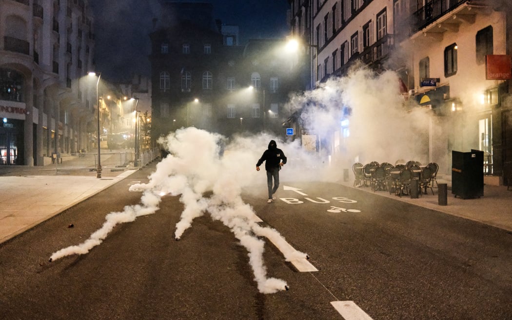 A protester stands alone between multiple gas canisters during a new “bloquons tout” mobilization in Clermont-Ferrand France on September 11 2025. (Photo by Romain Costaseca / Hans Lucas via AFP)