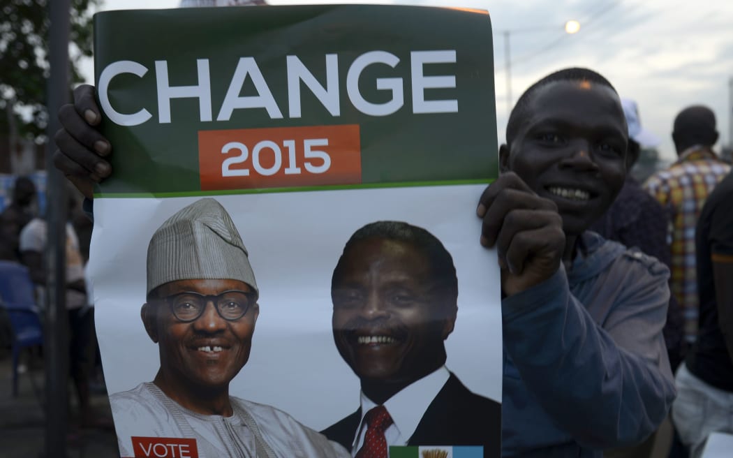 A supporter of the All Progressives Congress (APC) celebrates the election win.