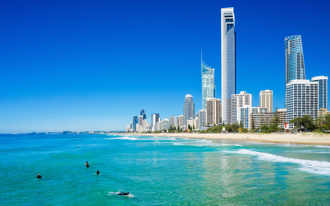 Surfers catching waves in  Surfers Paradise on the Gold Coast, QLD, Australia