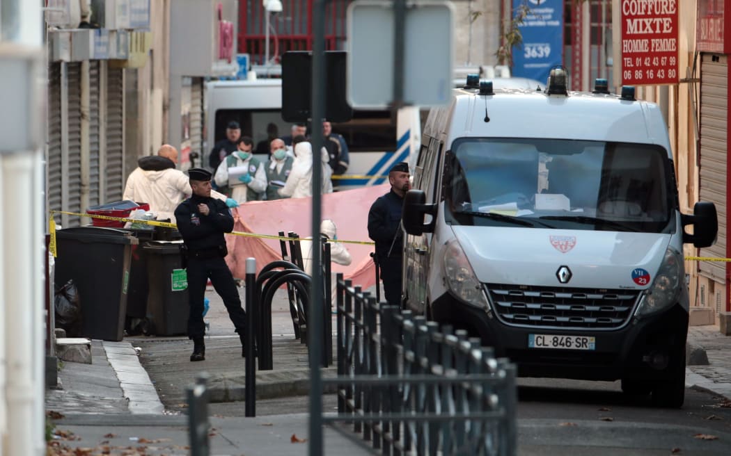 Riot police and forensics teams outside the Saint-Denis building raided by police on Wednesday.