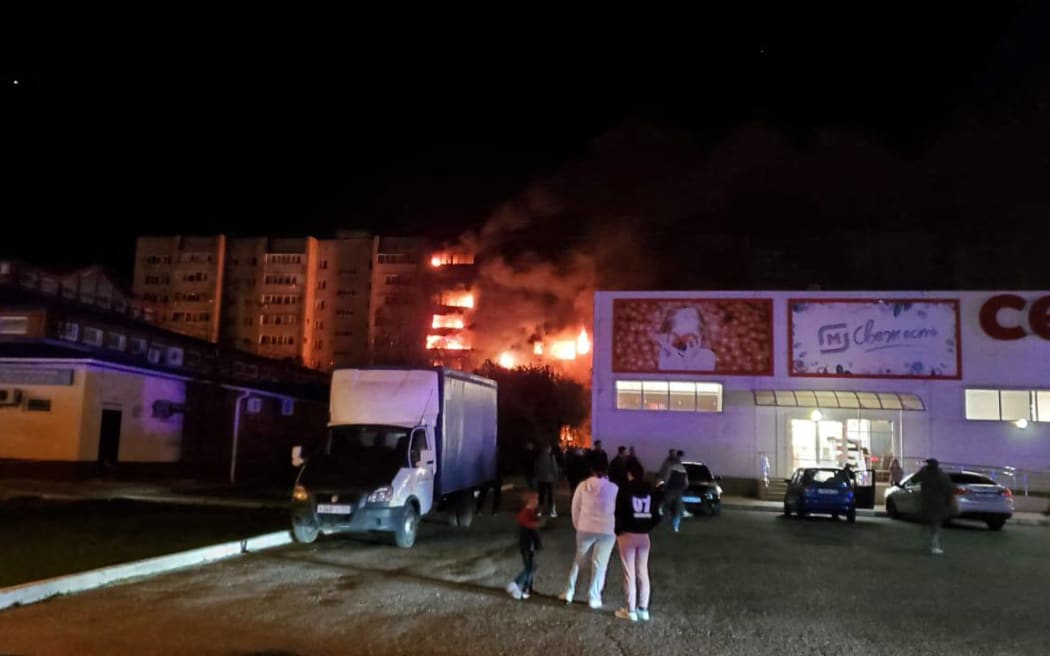 This handout picture posted on October 17, 2022 on the Telegram account of the Krasnodar region Prosecutor's Office shows an apartment building on fire after a Russian military plane crashed into a residential area of the town of Yeysk in southwestern Russia.