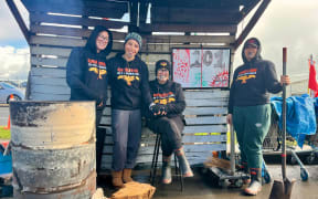 Te Owaina Gibson, Te Kotuku Irwin-Stainon, Ngati Oneone Chairwoman Charlotte Gibson and Tahea Gibson stand by the "Reclamation of whenua" fire, which has been burning for 101 days.