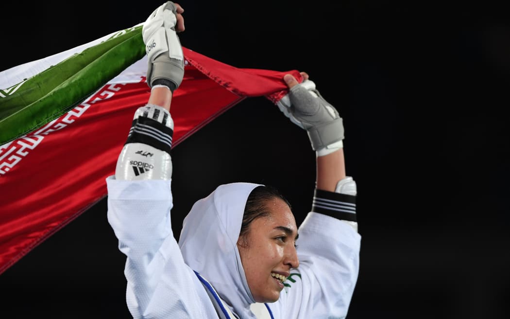 Iran's Kimia Alizadeh Zenoorin celebrates after winning womens taekwondo bronze medal bout in the -57kg category as part of the Rio 2016 Olympic Games,