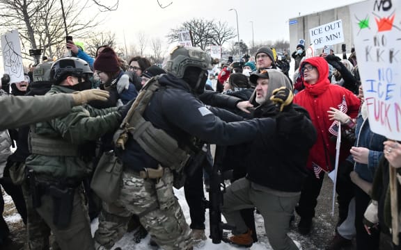 Protestors clash with federal agents outside the Bishop Henry Whipple Federal Building in Saint Paul, Minnesota, on January 8, 2026.