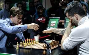 Magnus Carlsen and Ian Nepomniachtchi prepare to play in the World Blitz Chess Championship final on Tuesday.