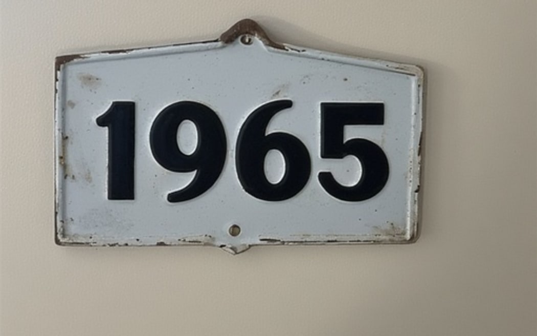 The number 1965 on a wall sign