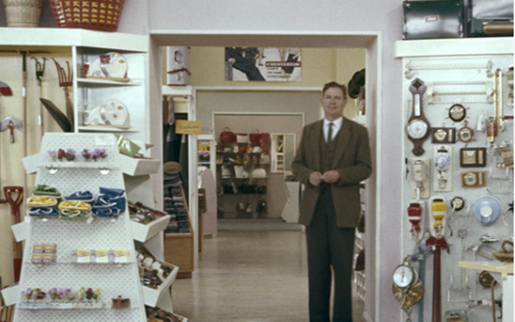 Man in suit in a general store.