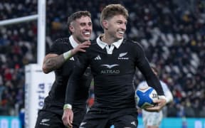 Beauden Barrett celebrates after scoring a try with TJ Perenara.
