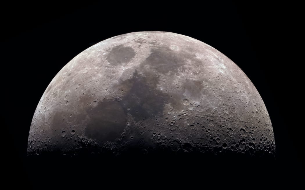 Moon, view through a telescope. The moon with craters. Real photos of space objects through a telescope. Natural background.