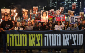 Demonstrators take part in a protest calling for action to secure the release of Israelis held hostage in Gaza since the October 2023, in front of the Israeli defence ministry in Tel Aviv on January 15, 2025, amid the ongoing war between Israel and the militant Hamas group. Israel said on January 15 that several points in the Gaza ceasefire and hostage release deal still needed to be resolved but expected them to be "finalised tonight," even as news spread that an agreement with Hamas had been reached. (Photo by Jack GUEZ / AFP)