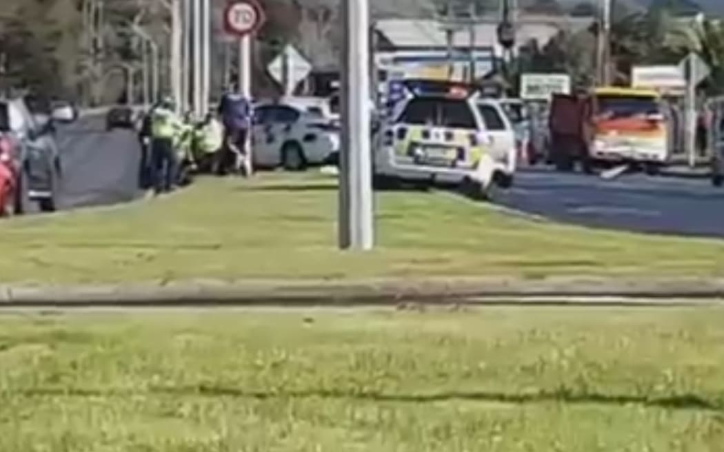 A screenshot from a video posted to Facebook, showing police gathered at the scene of the shooting in Rotorua.