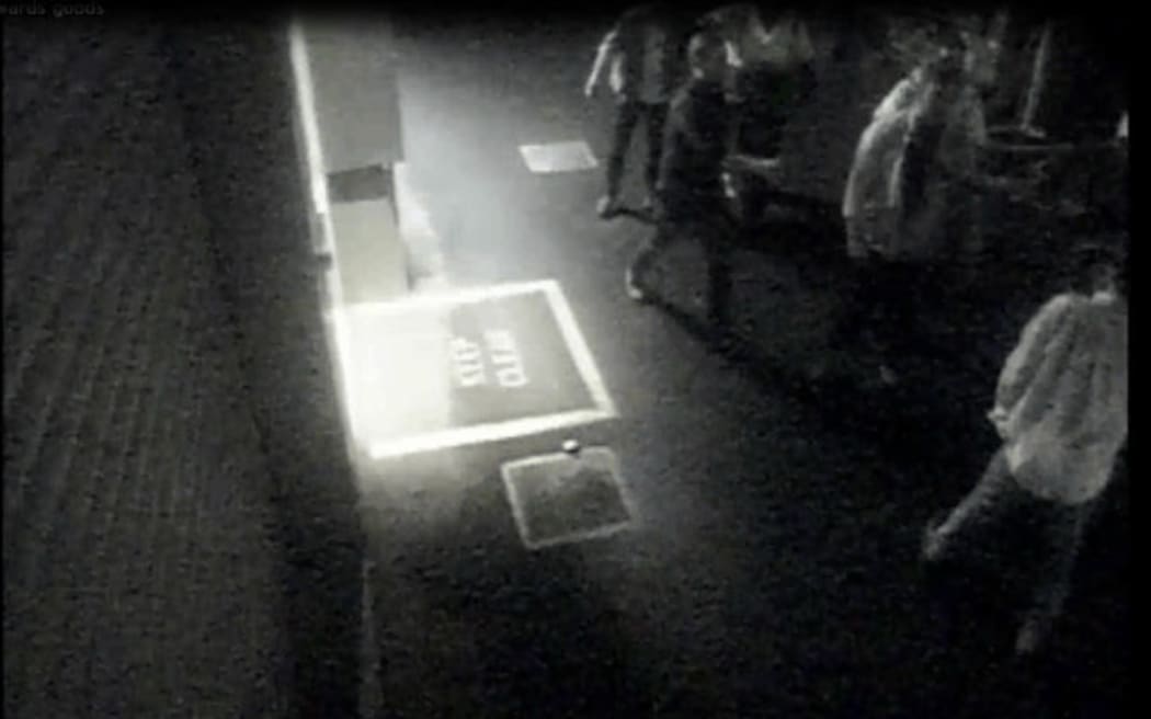 Police released images showing one of the alleged attackers, facing the camera with his shirt unbuttoned.