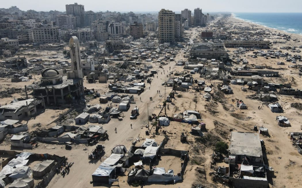 An aerial view shows tents sheltering displaced Palestinians in the war-damaged area surrounding Gaza City's port on October 20, 2025, during a US-brokered ceasefire between Israel and Palestinian factions. (Photo by AFP)