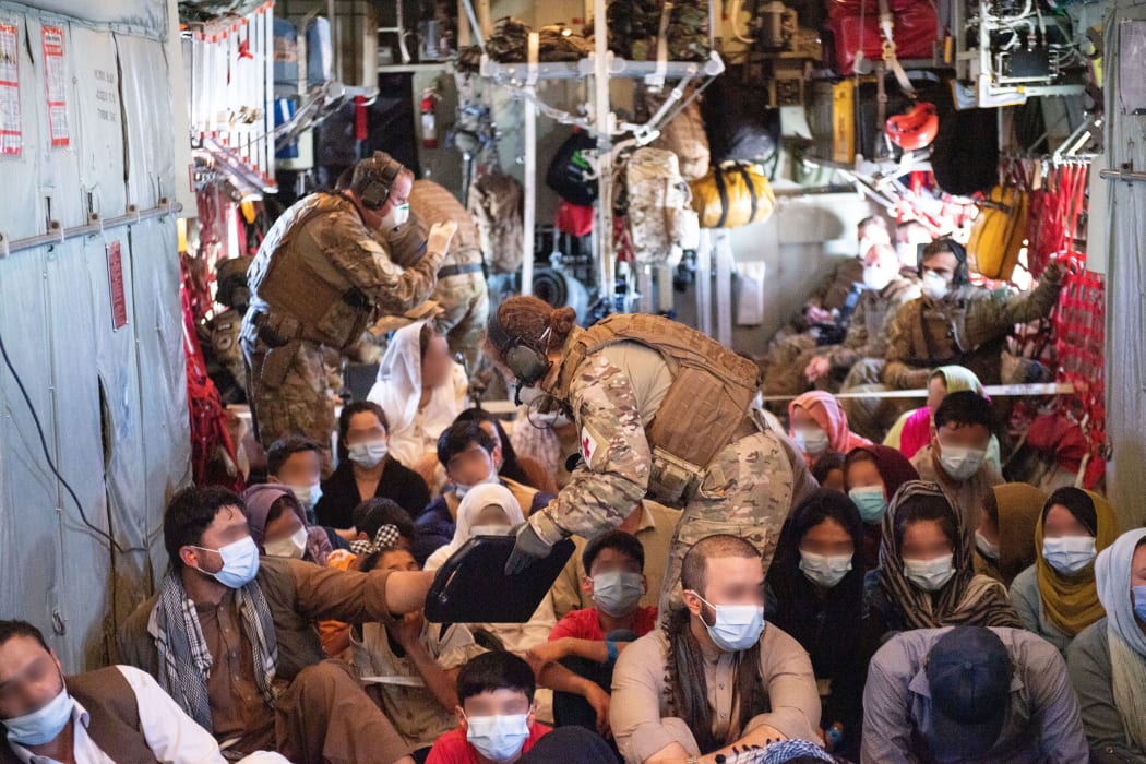 Evacuees preparing to leave Afghanistan (faces are blurred for privacy).