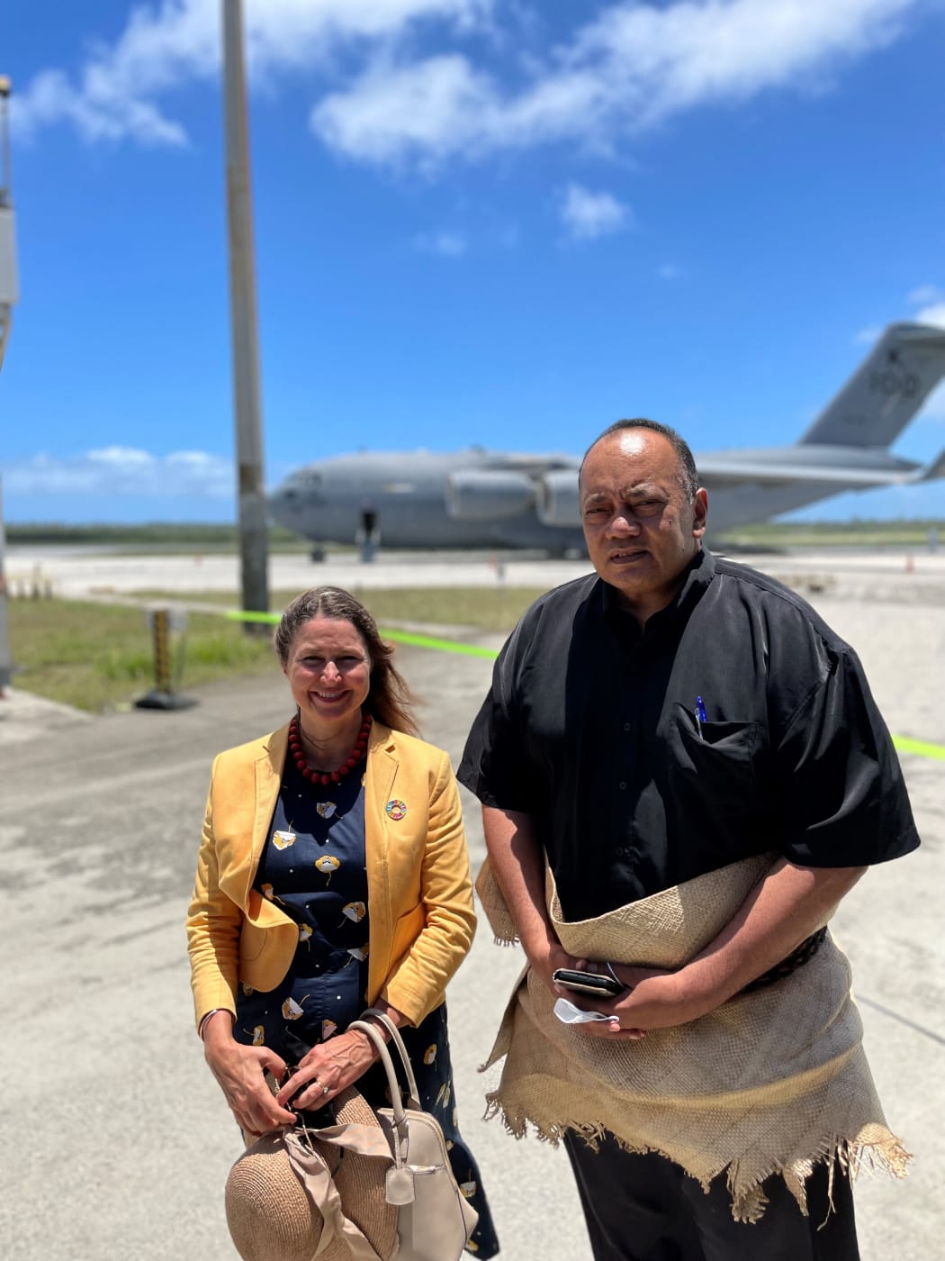 Tonga's Prime Minister Siaosi Sovaleni (right) joined by Australia's High Commissioner to Tonga Rachael Moore (left) to witness the arrival of the first Royal Australian Air Force C-17A Globemaster III aircraft from Australia delivering humanitarian assistance on January 20, 2022.