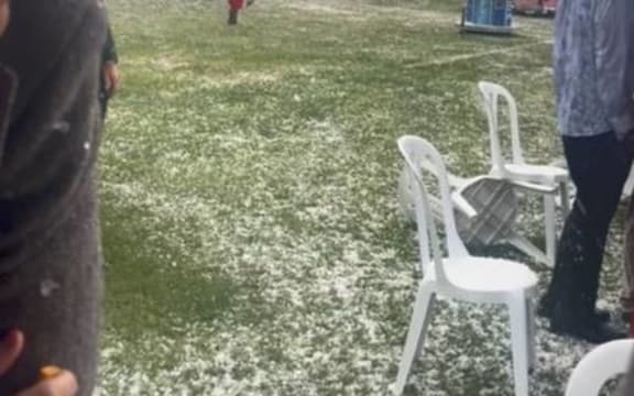 Cup Week patrons scramble for cover during a hailstorm at Riccarton Park.