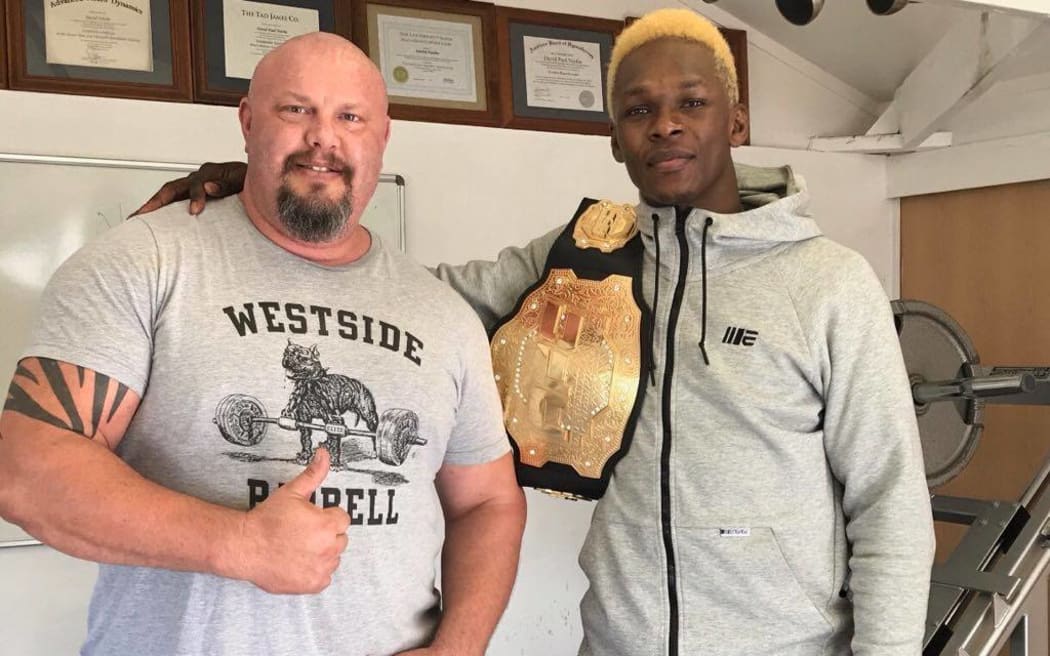 Mental performance coach and author David Niethe, with MMA champion Israel Adesanya.