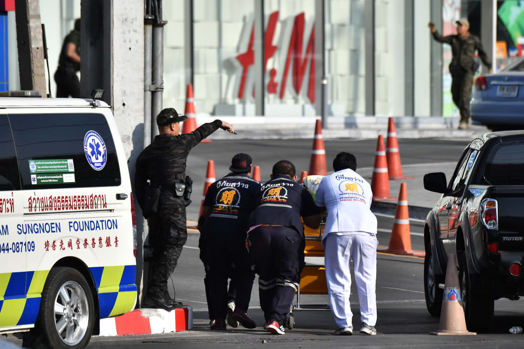 Medics prepare to bring a stretcher into the Terminal 21 mall.
