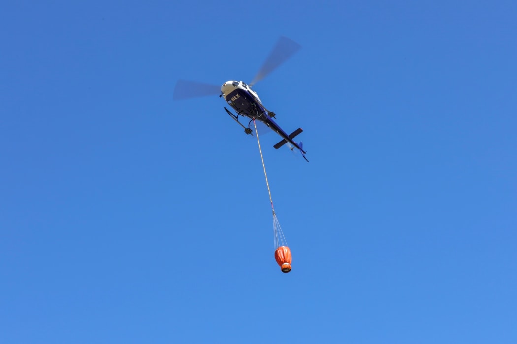 Water bombers fill up before returning to fight the Nelson bushfire.