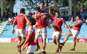 Tonga celebrate after Uruguay missed a conversion attempt with the final kick of the game.