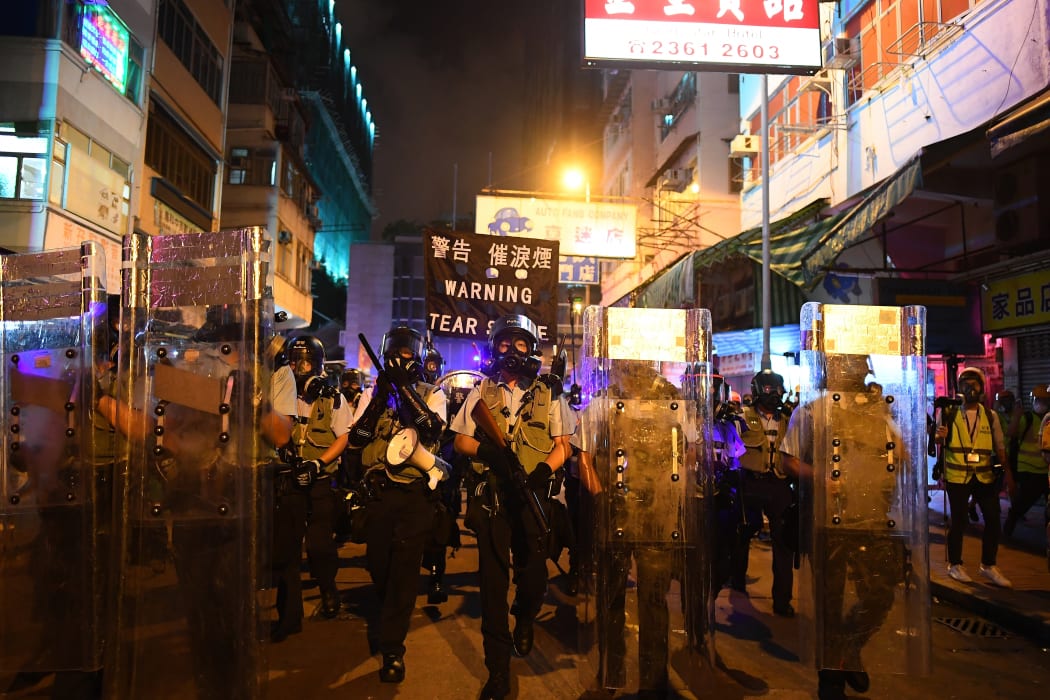Policemen secure a street after dispersing pro-democracy protestors in the Sham Shui Po Area of Hong Kong.
