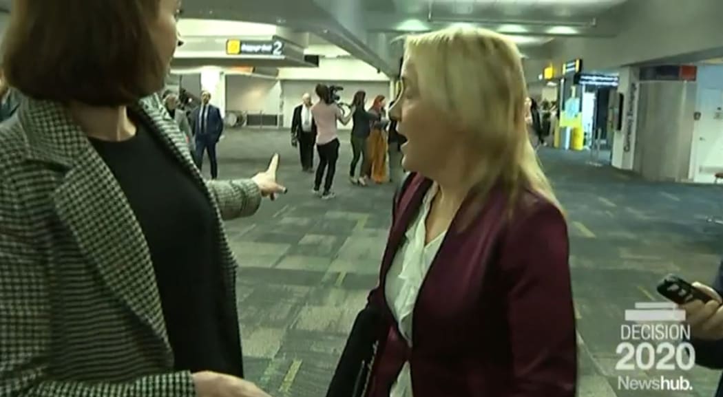 "She's behind you . . . " Tova O'Brien points to media pursuing inbound Judith Collins while pursuing inbound Nikki Kaye at the airport.
