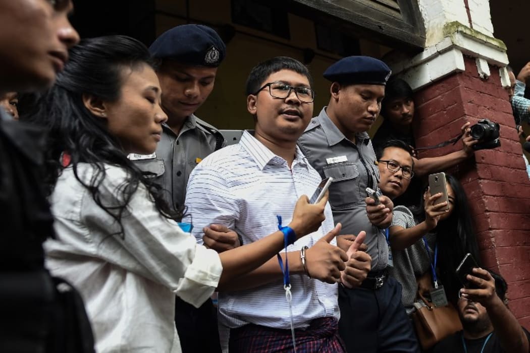 Reuters journalist Wa Lone speaks to journalists outside court.