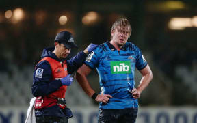 Josh Goohue of the Blues is escorted off the field for a concussion test.