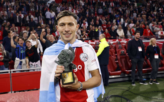 Ajax's Lisandro Martinez poses with the Rinus-Michels player of the year award after Ajax won the 36th Dutch Eredivisie title