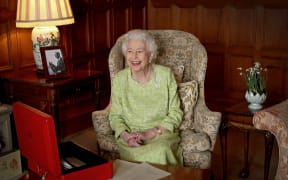 A Buckingham Palace handout image released on 6 February shows Britain's Queen Elizabeth II smiling as she sits in Sandringham House in Norfolk, eastern England on February 2, 2022, released to mark the start of Her Majesty's Platinum Jubilee Year.