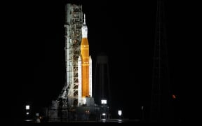 In this handout image released by NASA, the Artemis rocket with the Orion spacecraft aboard is seen atop the mobile launcher at Launch Pad 39B, at the Kennedy Space Center in Cape Canaveral, Florida, on August 29, 2022, as the Artemis I launch teams load more than 700,000 gallons of cryogenic propellants as the launch countdown progresses. AFP / Joel Kowsky / NASA " - NO MARKETING - NO ADVERTISING CAMPAIGNS - DISTRIBUTED AS A SERVICE TO CLIENTS