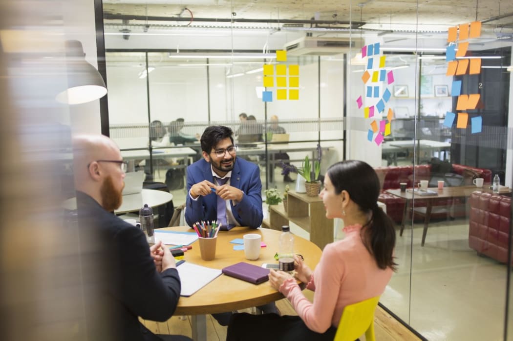 Creative business people brainstorming in conference room meeting.
