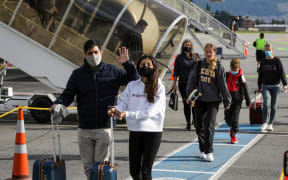 Passengers arriving in Queenstown on the first flight from Auckland on Wednesday 15 December 2021.