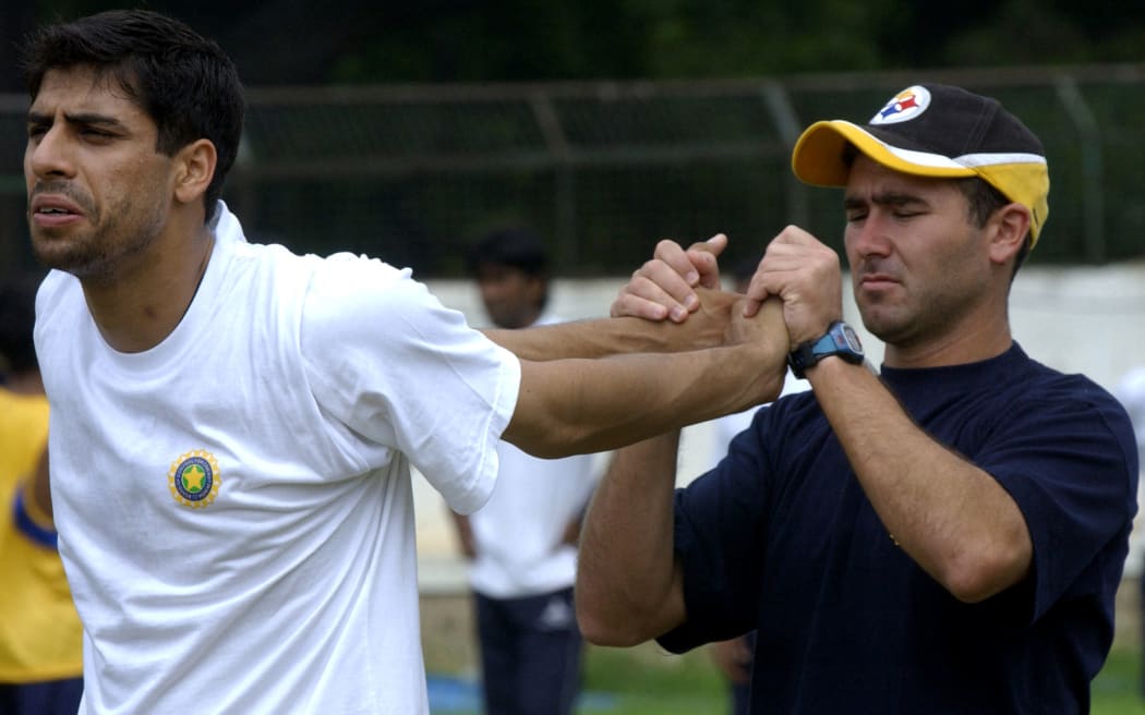 Indian Cricket Team Physical Trainer Gregory Allen King (R) helps Fast Bowler Ashish Nehra with a piece during the training on the fourth day of the Fast Bowlers Fitness Camp in the National Cricket Academy (NCA) in Bangalore, 11 June 2004.