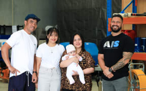 Joel Macarubbo, Tarri Caraquez and their children Jeomille, 15, and Beau, four months, with Joel's new employer, Mike Milligan, co-founder of AIS Global.