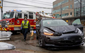A first responder attends to a collision on February 01, 2023 in Austin, Texas. A winter storm is sweeping across portions of Texas, causing massive power outages and disruptions of highways and roads.