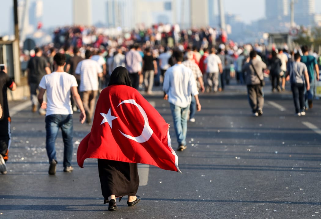 Crowds in the streets after a group of soldiers with armored vehicles involved in the coup attempt are neutralised by police at Bosphorus Bridge in Istanbul.