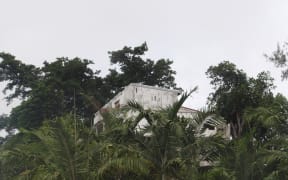 Land and building seen from street below