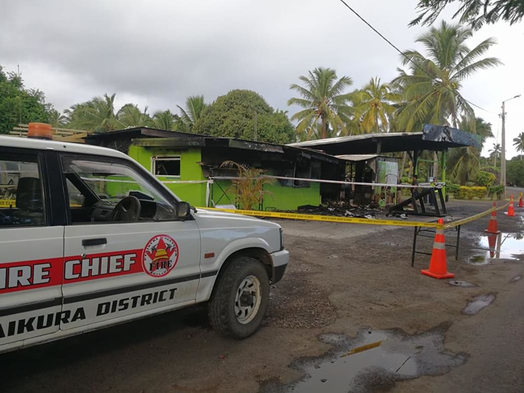 Fire authorities attend the site of one of the fires in Arorangi