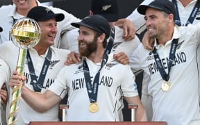 New Zealand's captain Kane Williamson (C) holds the winner's Mace as New Zealand players celebrate victory on the final day of the ICC World Test Championship Final between New Zealand and India at the Ageas Bowl in Southampton, southwest England on June 23, 2021.