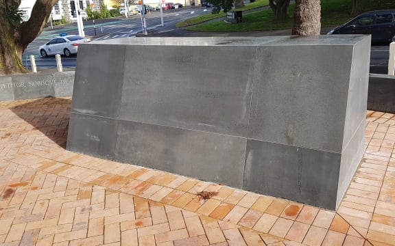 The judge's name has been removed from the large marble plinth.