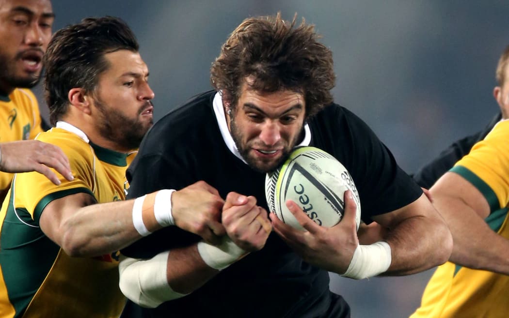 All Blacks lock Sam Whitelock tries to break the tackle of Wallabies centre Adam Ashley-Cooper. Bledisloe Cup Rugby Union Test Match. Eden Park, Auckland, New Zealand. Saturday 23 August 2014.