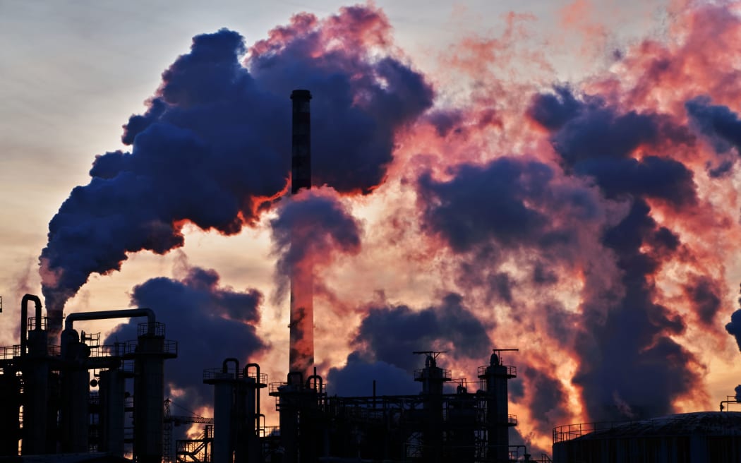 36632031 - chimneys and dark smoke over chemical factory at sunset