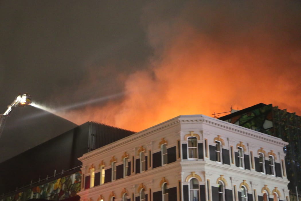 The smoke billowing from the rooftop of the SkyCity convention centre is lit up by the flames into the night. (22 October)
